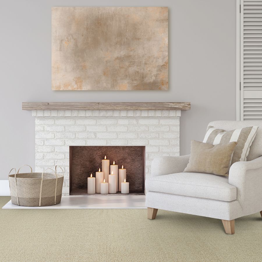 light sand-toned, jute natural carpet in living area with brick fireplace and white armchair