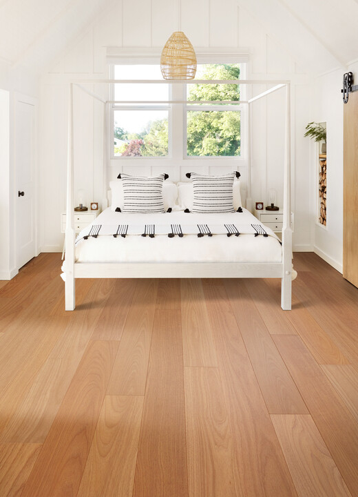 hardwood flooring in bedroom with white four-post bed